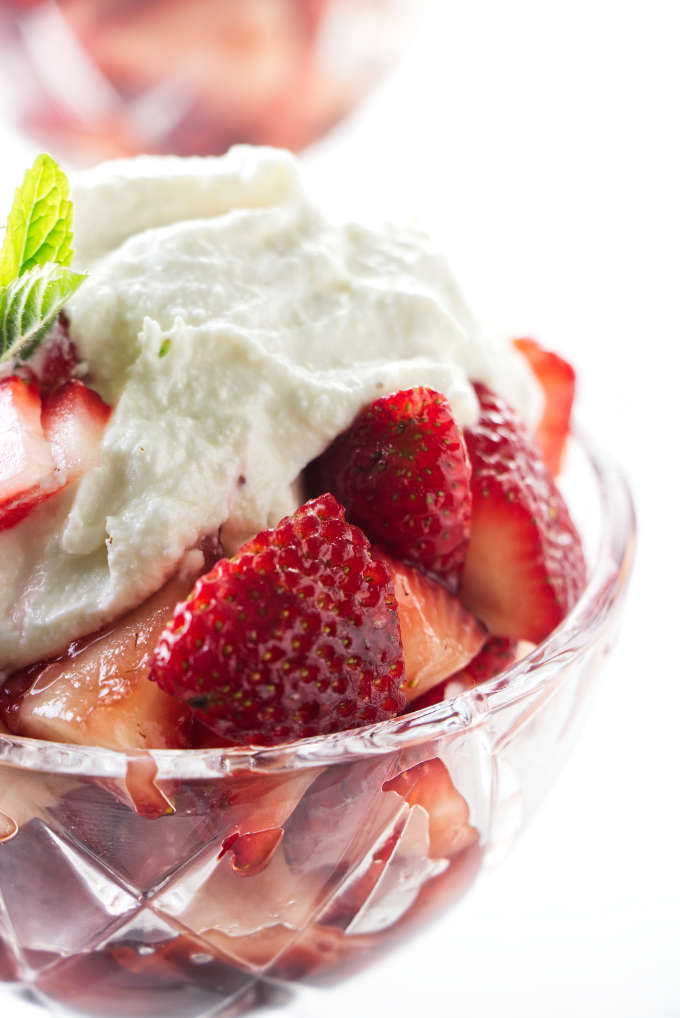 A dish of marsala strawberries with sweetened ricotta on top.