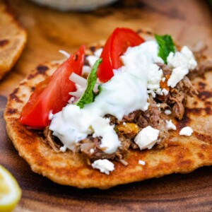 Pita bread topped with left over beef and tzatziki sauce.