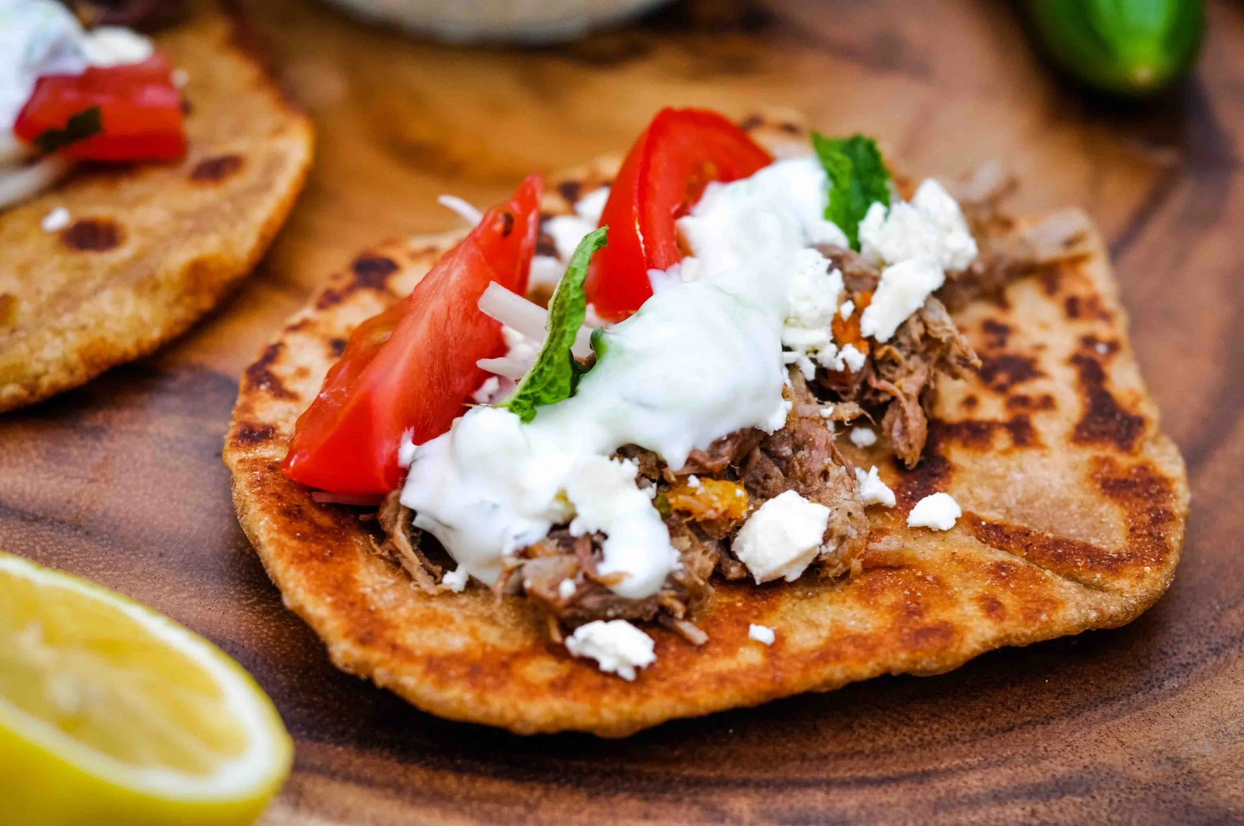 Pita bread topped with left over beef and tzatziki sauce.