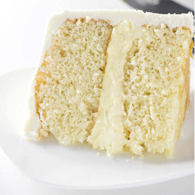 A slice of yellow cake from a 6 inch round cake.