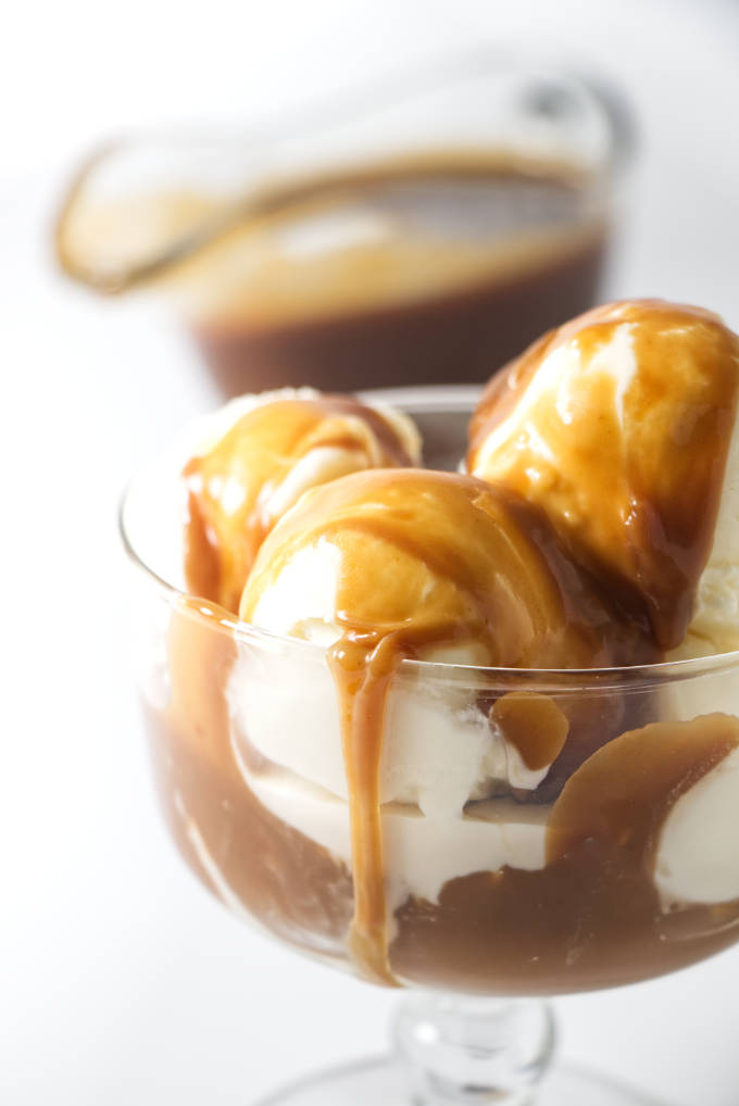 Butterscotch sauce over a dish of vanilla ice cream.