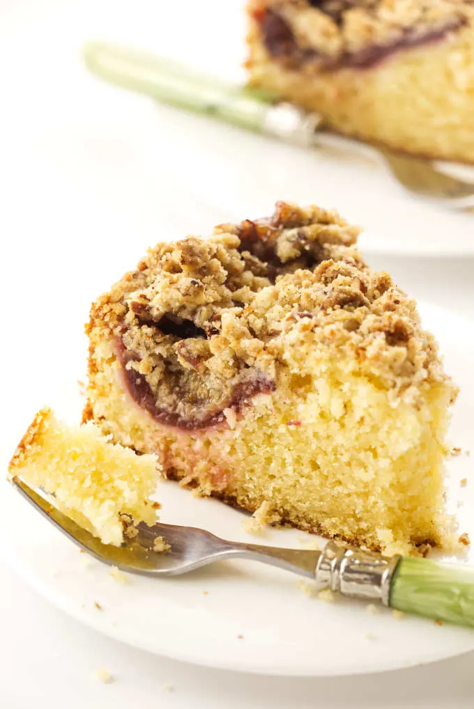 Close up view of a slice of fresh fig cake and a bite on a fork