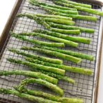 A baking sheet with asparagus fresh out of the oven.