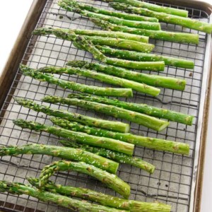 A baking sheet with asparagus fresh out of the oven.