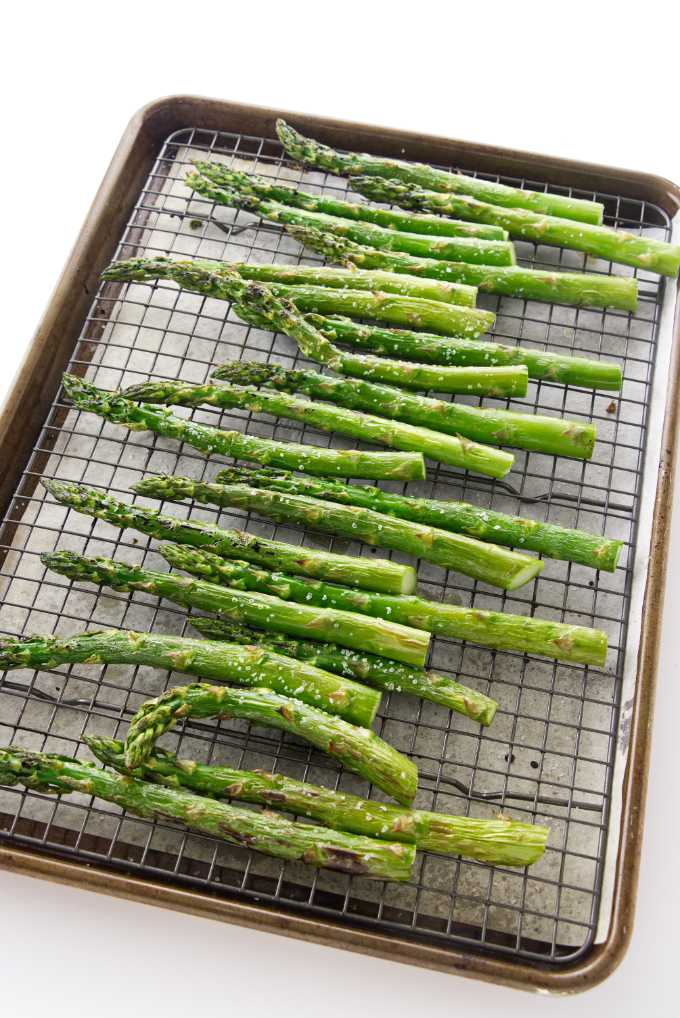 A baking sheet with asparagus fresh out of the oven.