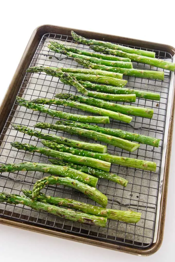A baking sheet with roasted asparagus fresh out of the oven.