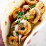 A shrimp fajita in a flour tortilla.