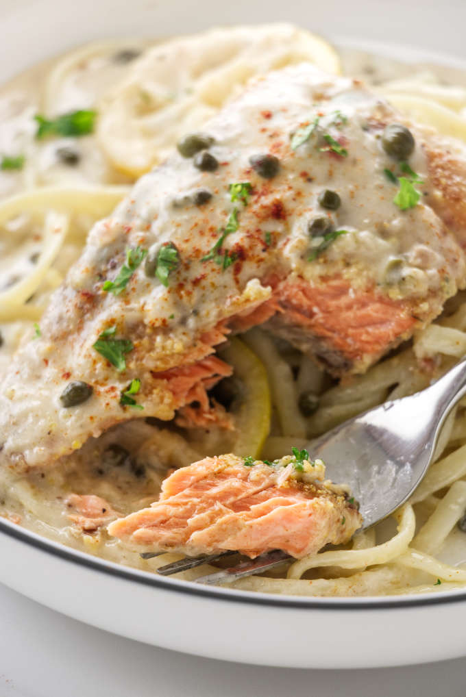 Close up photo of a bite of salmon on a fork