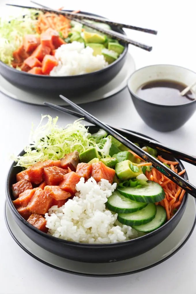 Two servings of spicy salmon sushi bowls