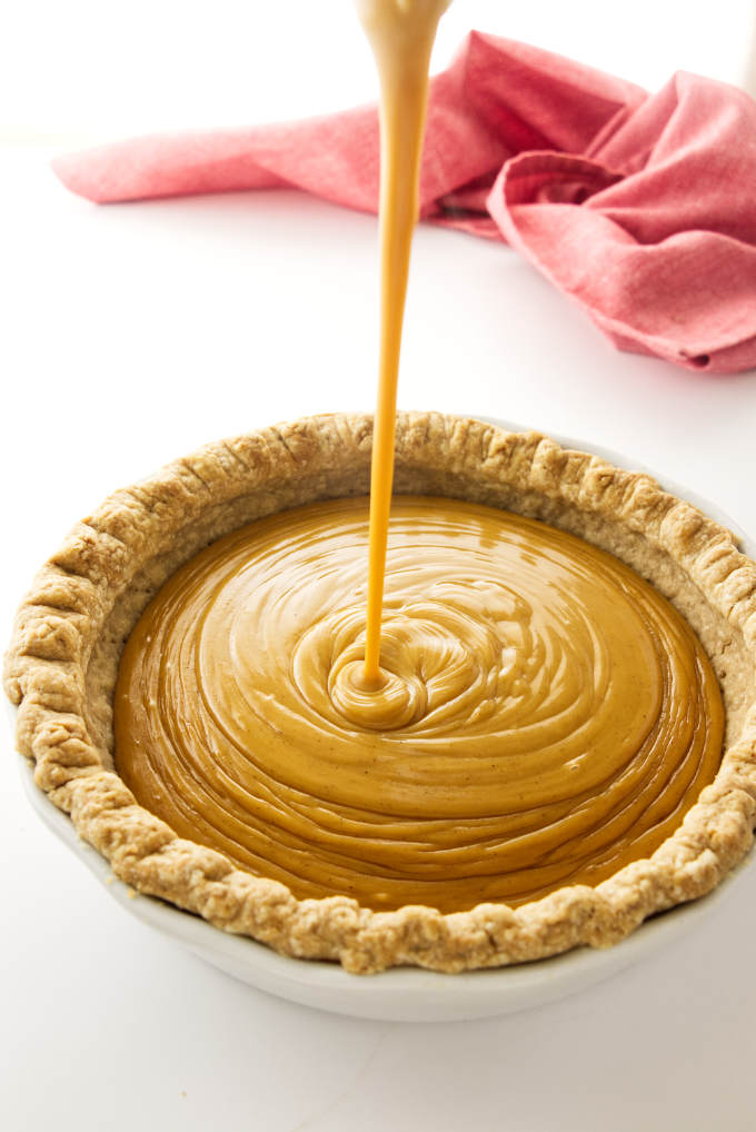 Butterscotch Cinnamon Pie filling being poured into a baked cinnamon pastry crust