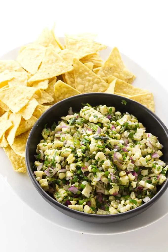 close up view of chipotle corn salsa and corn tortilla chips