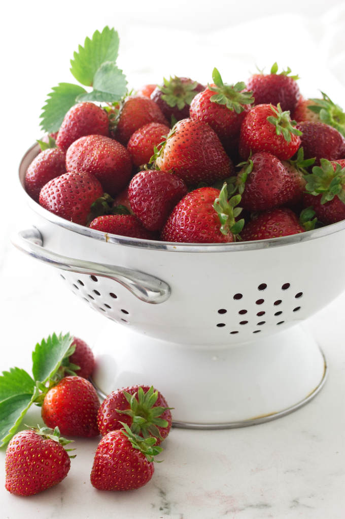 Fresh strawberries in a colander.