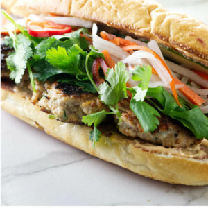 A chicken banh mi sandwich with chicken meatballs.