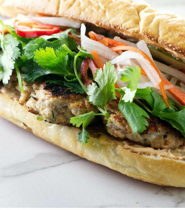 A chicken banh mi sandwich with chicken meatballs.