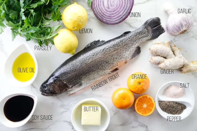 Ingredients needed for a baked rainbow trout recipe.