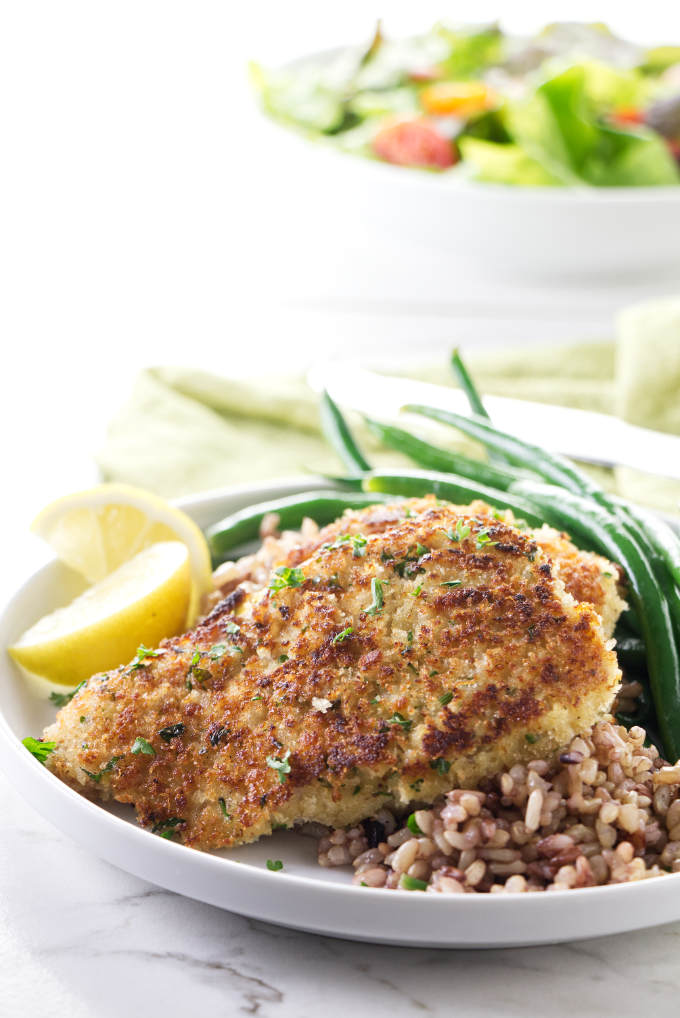 Crispy rockfish fillets on a dinner plate with wild rice blend and green beans.