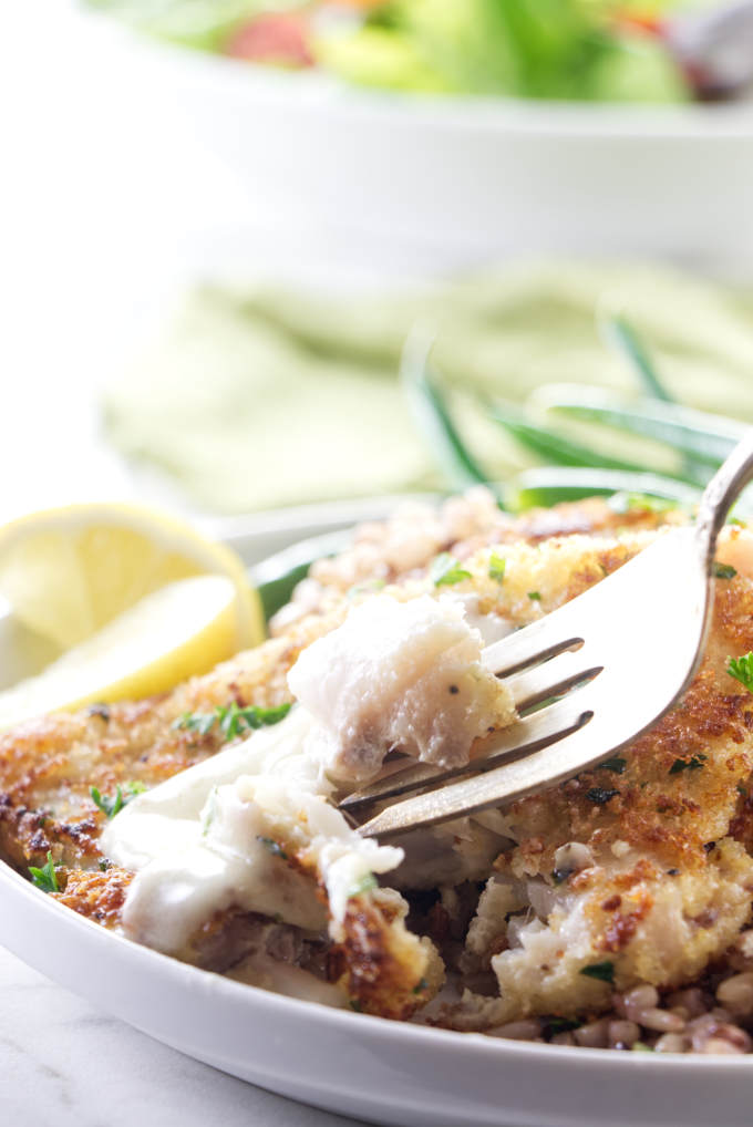 A fork flaking off a piece of rockfish.