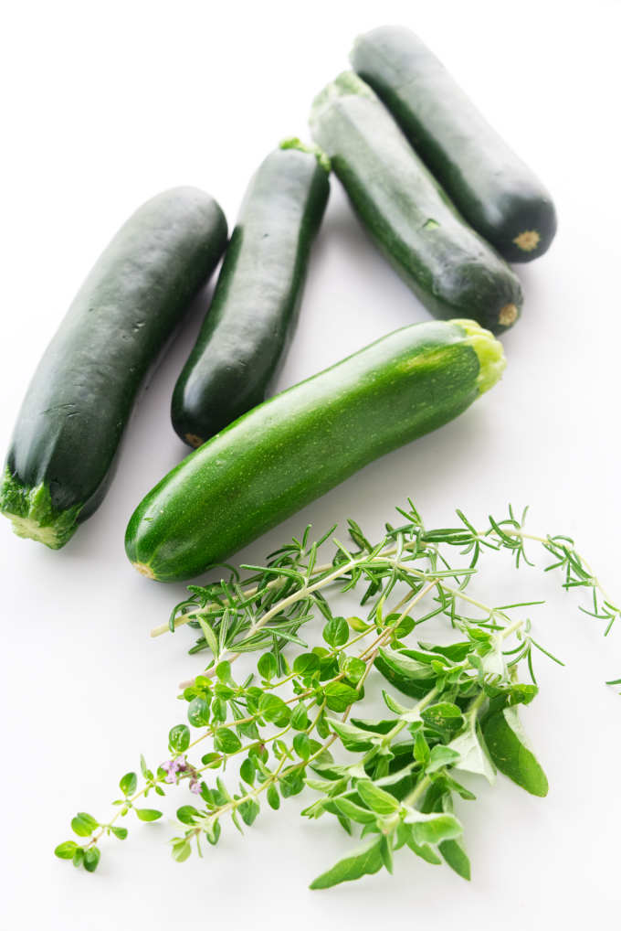 Fresh zucchini and herbs ready to be sliced for dinner.