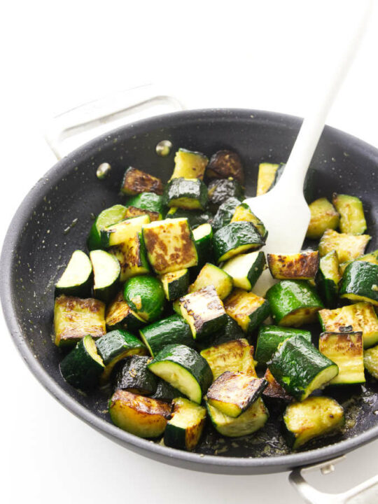 Slices of zucchini in a saute pan.