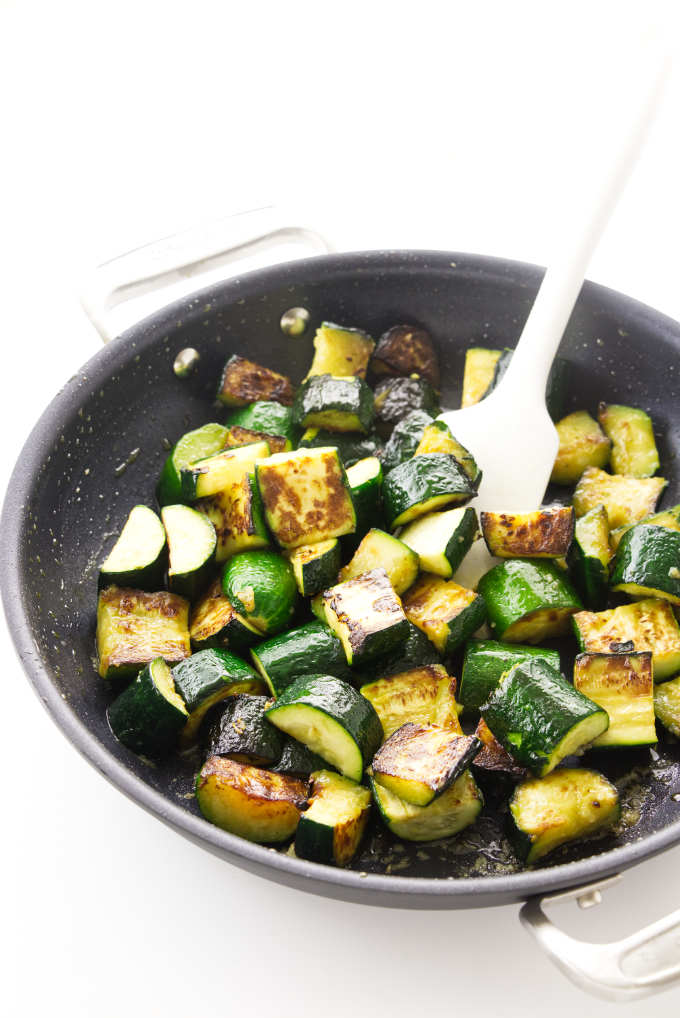 Slices of zucchini in a saute pan.
