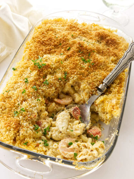 A 13 x 9 baking dish with baked seafood mac and cheese.