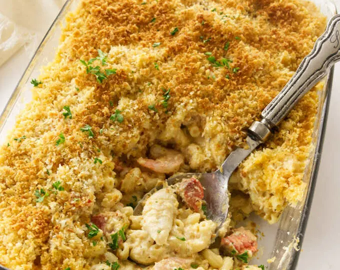 A 13 x 9 baking dish with baked seafood mac and cheese.