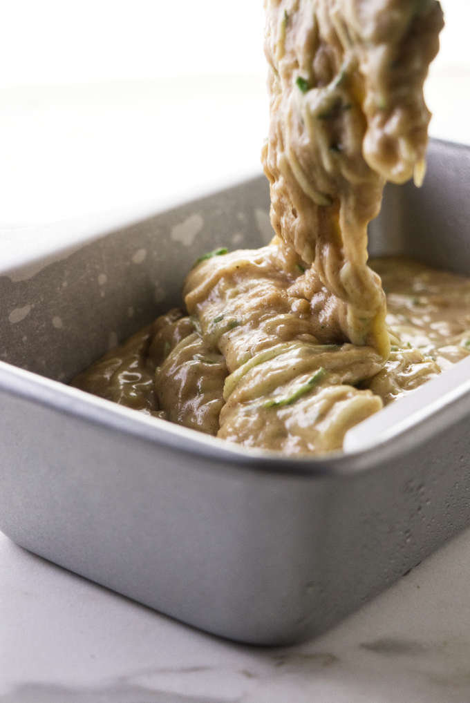 Pouring the batter for brown sugar zucchini bread into a bread pan.