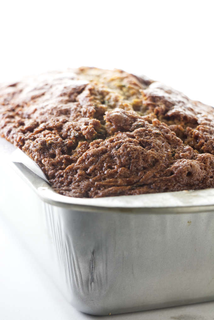 A loaf of zucchini bread in a baking pan.