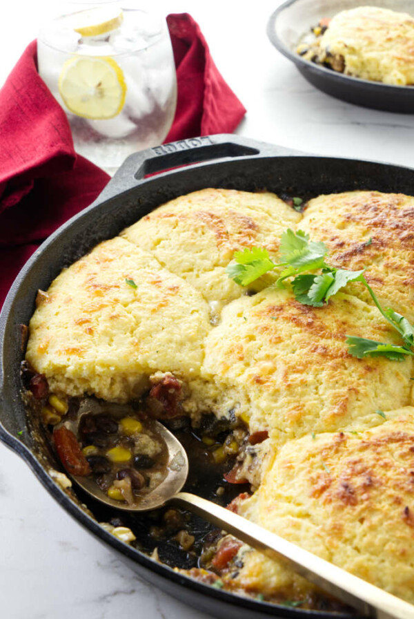 A spoon scooping a serving of Mexican cornbread casserole.