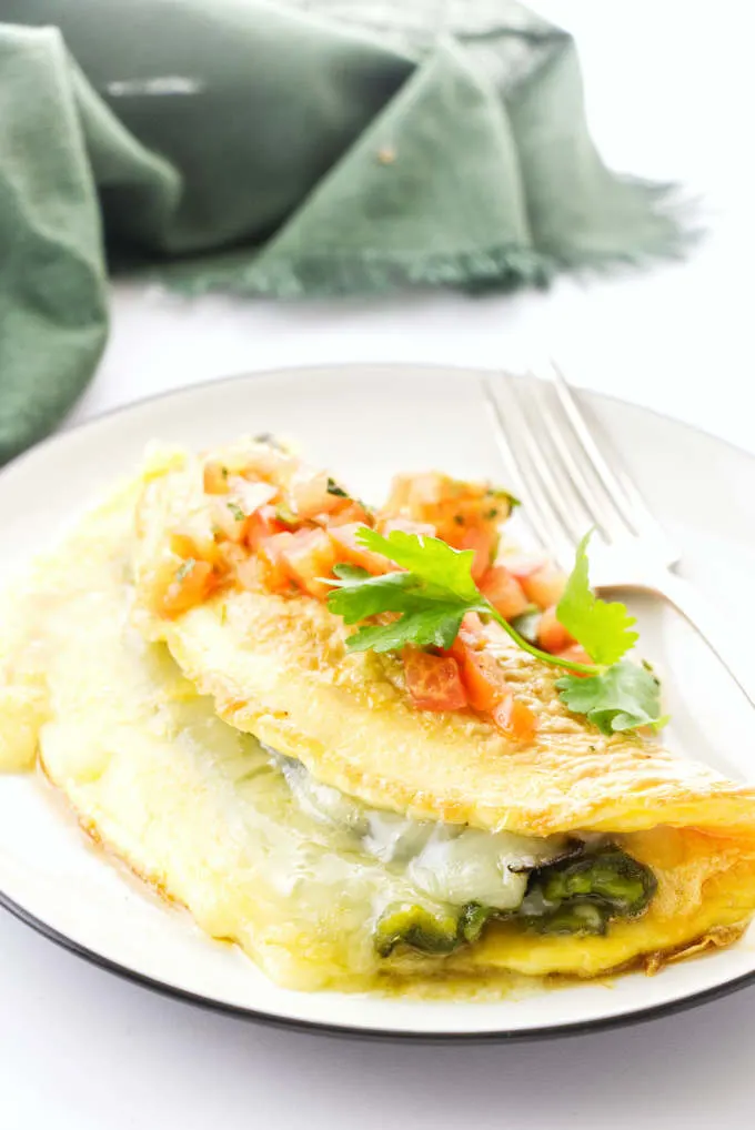 An omelet with a roasted poblano pepper inside.