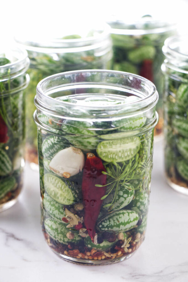 Several jars of pickled cucuamelons (Mexican sour gherkins).