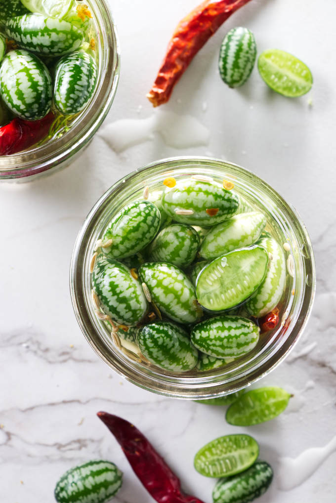 Pickled cucuamelons in a pint jar.