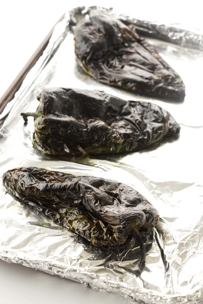 Poblano peppers on a baking sheet.