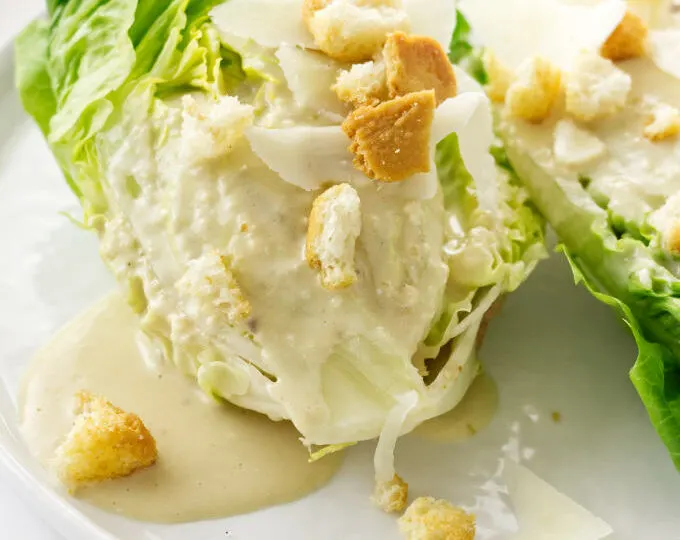 Close up view of Little Gem Caesar Salad on a plate with a fork