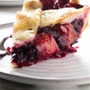 Blackberry peach pie on a dessert plate.