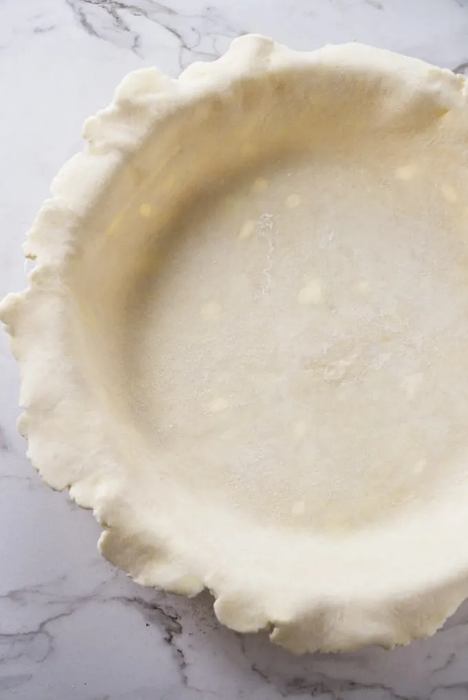 An all butter pie crust formed into a pie shell.