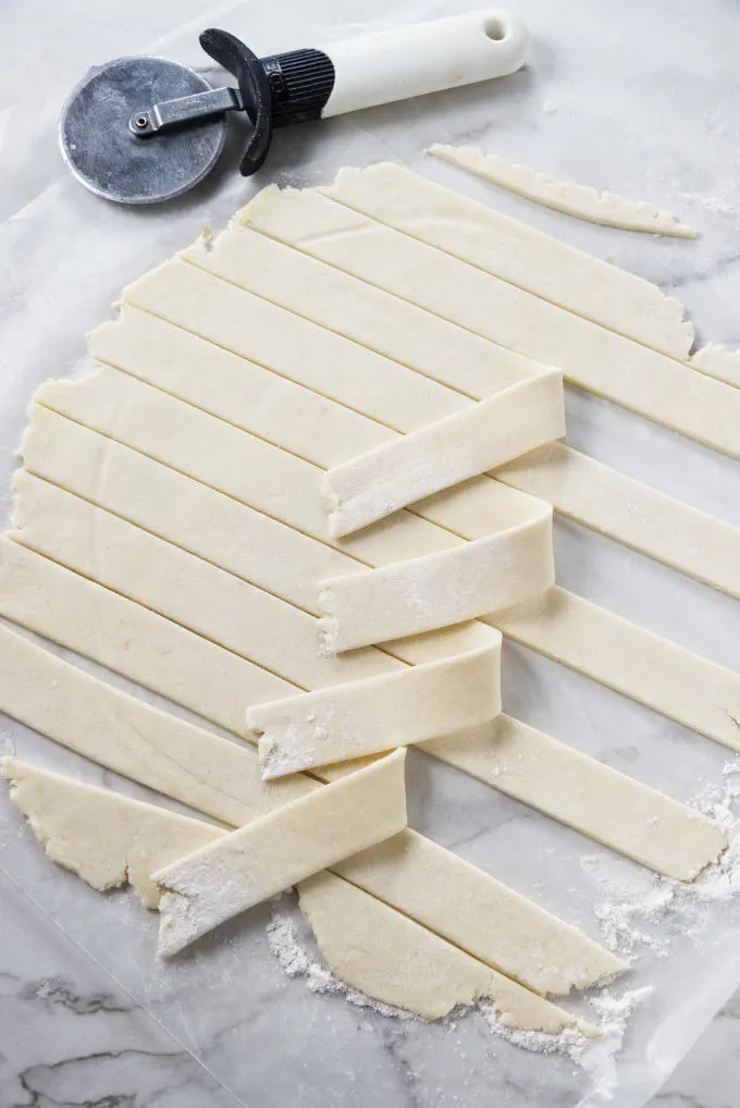 An all butter pie dough sliced into strips to make a lattice crust.