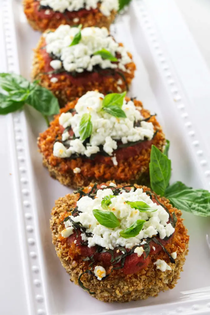Slices of baked eggplant rounds with goat cheese and marinara sauce.