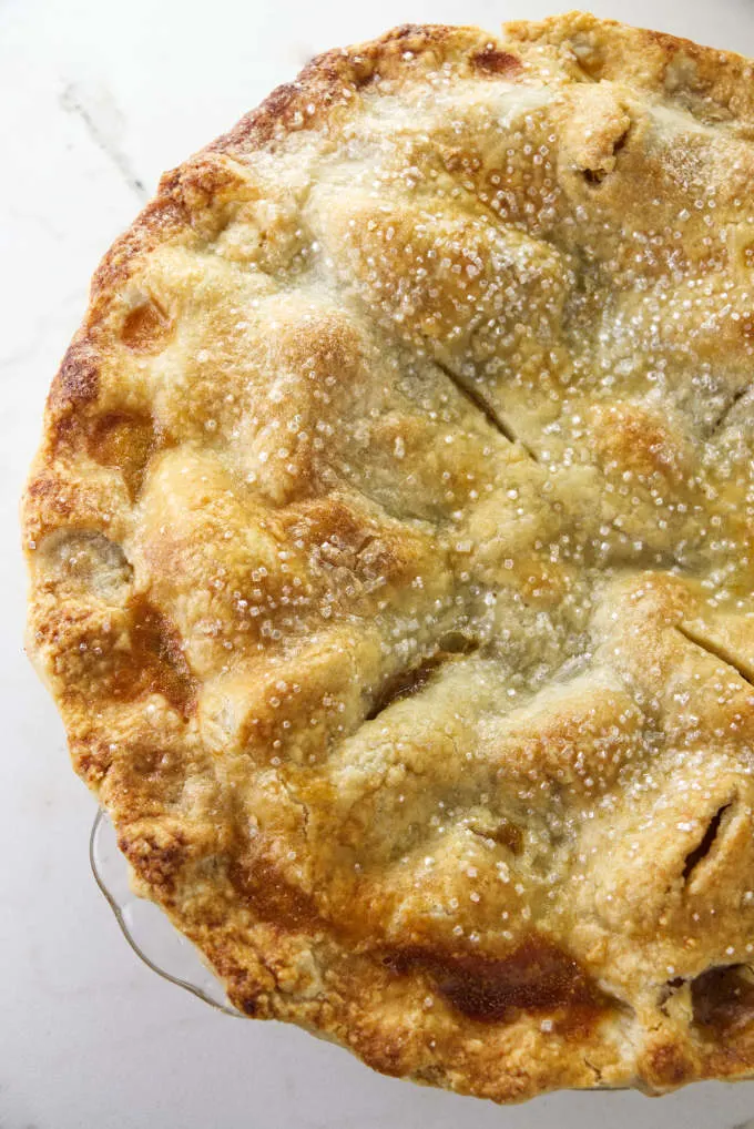 Freshly baked peach pie with sugar topped crust.