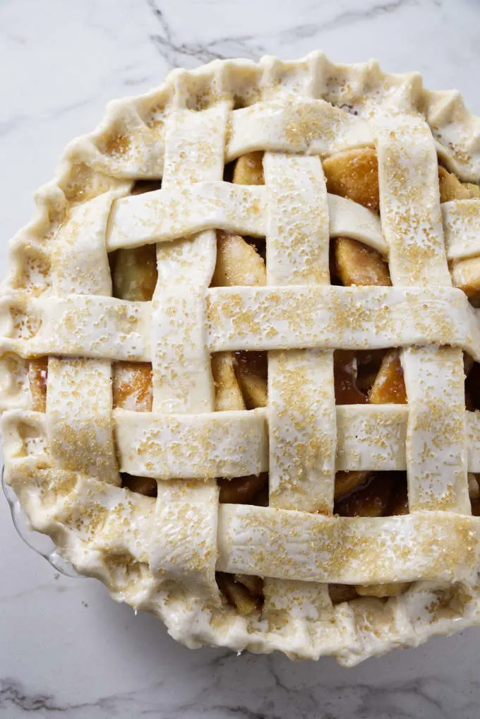 An unbaked apple pie with a lattice top.