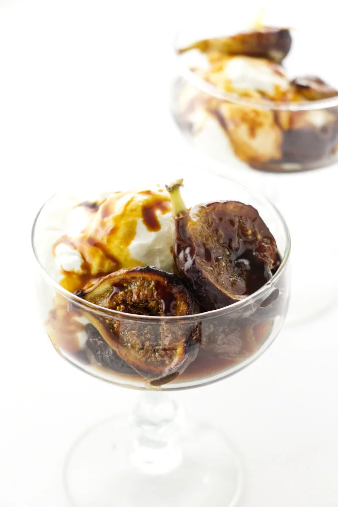 Overhead view of two servings of caramelized figs in a stem glasses