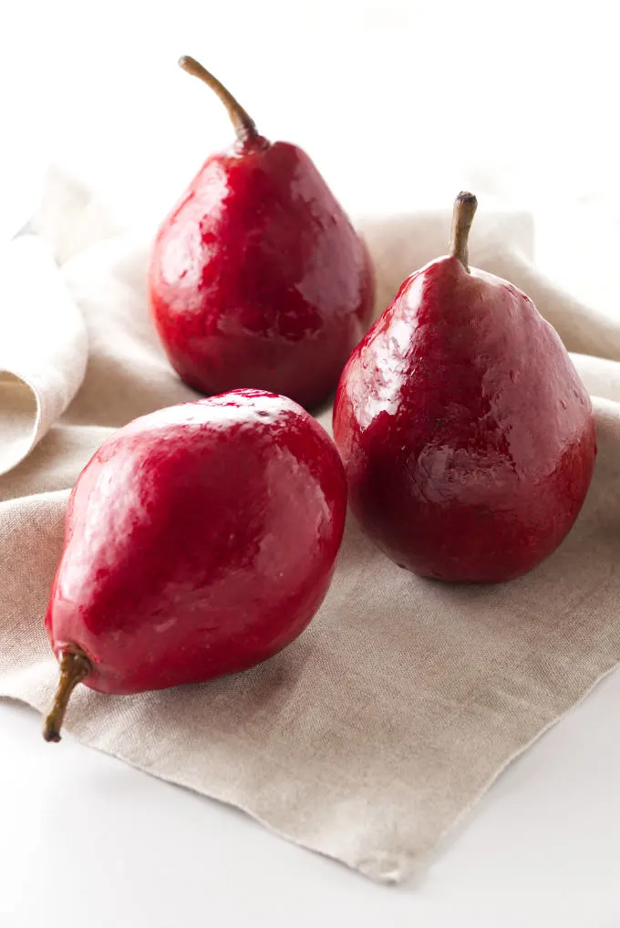 Three red pears on a napkin