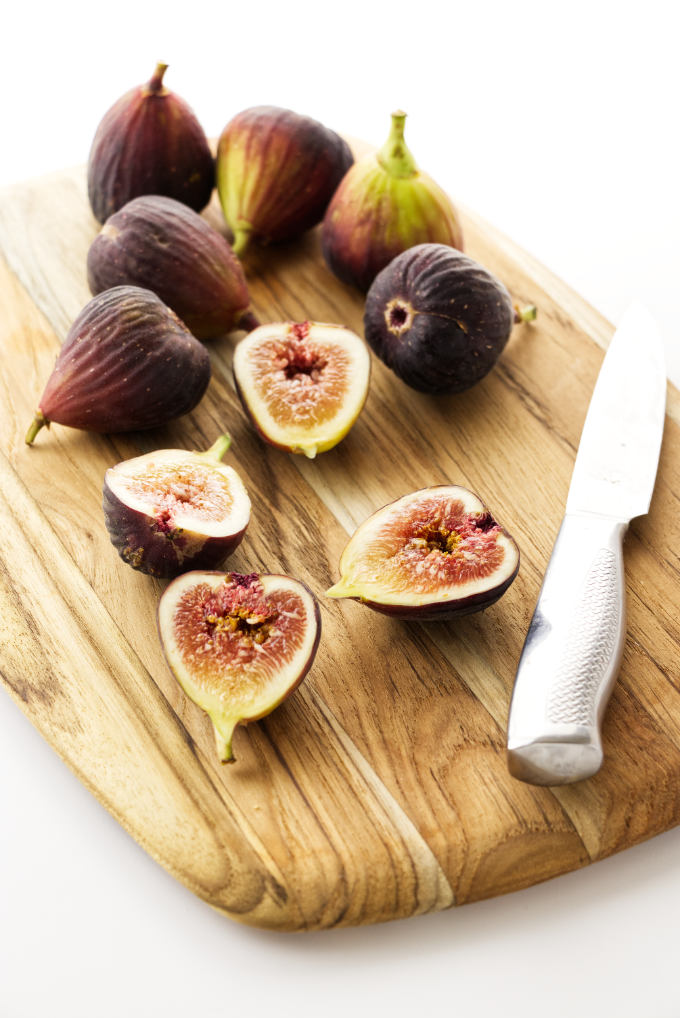 Figs on a cutting board with a knife