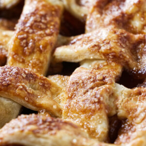 Close up of a lattice pie crust baked with sparkle sugar on top.