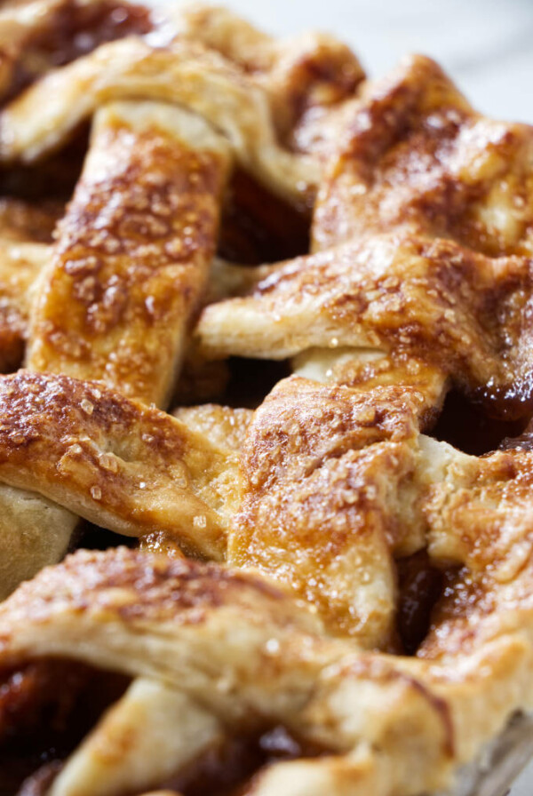 Close up of a lattice pie crust baked with sparkle sugar on top.