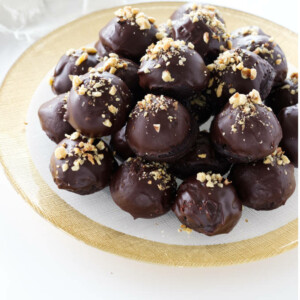 Close up of platter of ganache and nut garnished miso brownie bites