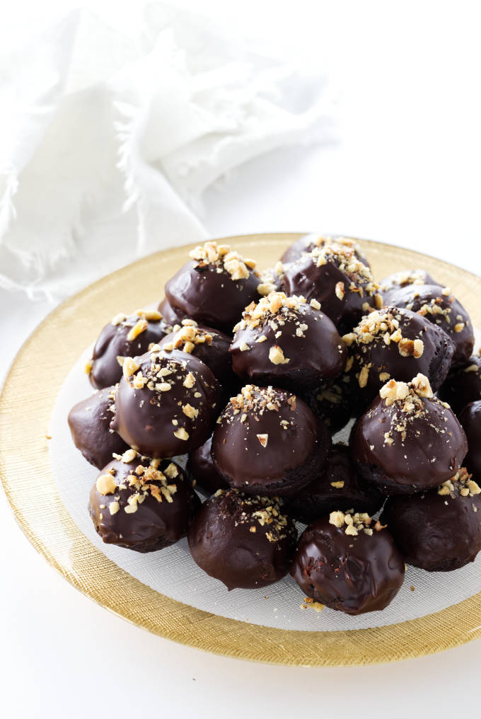 Platter of ganache and nut garnished miso brownie bites