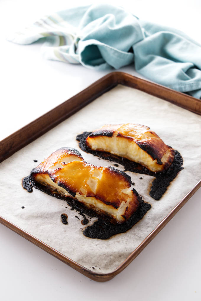 Two portions of baked miso sea bass filets. 