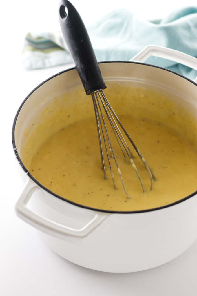 Making cheddar cheese sauce for macaroni and cheese.