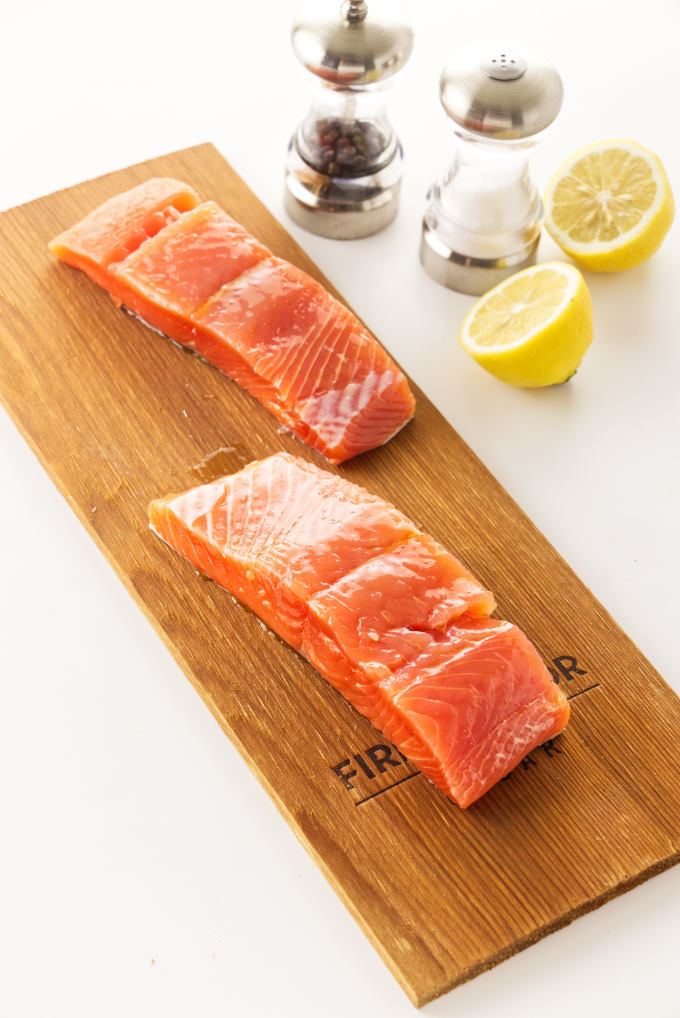 Two salmon fillets on a cedar plank